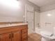 Bathroom featuring a wood vanity and a bathtub and shower combination at 9307 Harlow Creek Rd, Huntersville, NC 28078
