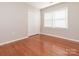 A bedroom with wood floors, neutral walls, a double window, and a closet at 9307 Harlow Creek Rd, Huntersville, NC 28078