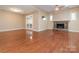 Spacious living area with stone fireplace, hardwood floors, and natural lighting at 9307 Harlow Creek Rd, Huntersville, NC 28078