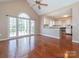 Bright living room featuring hardwood floors and large windows with abundant natural light at 9307 Harlow Creek Rd, Huntersville, NC 28078