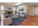Cozy living room featuring a stone fireplace, stylish decor, and comfortable seating at 9307 Harlow Creek Rd, Huntersville, NC 28078