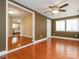 The living room has hardwood floors and a view to the kitchen, with neutral paint and a modern ceiling fan at 9307 Harlow Creek Rd, Huntersville, NC 28078