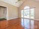 Sun-drenched living room with hardwood floors and an arched window at 9307 Harlow Creek Rd, Huntersville, NC 28078