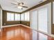 Bright sunroom featuring a ceiling fan, hardwood floors, and sliding glass doors for seamless indoor-outdoor living at 9307 Harlow Creek Rd, Huntersville, NC 28078