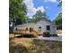 Exterior view of a white house with a new wooden deck, concrete patio, and well-maintained lawn at 1003 Woodland Dr, Gastonia, NC 28054