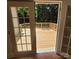 View through french doors onto a newly constructed wood deck with railing at 1003 Woodland Dr, Gastonia, NC 28054