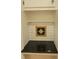 Close-up of built-in alcove featuring black countertop and white backsplash with decorative tile at 1003 Woodland Dr, Gastonia, NC 28054