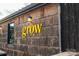 Unique storefront exterior with natural wood siding and a bright, yellow 'grow' sign, showcasing a modern design at 1011 Carter Ave # 35, Charlotte, NC 28206