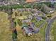An aerial view showcasing the townhome community with mature trees and parking at 1022 Mallard Head Ln, Mooresville, NC 28117