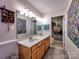 Spacious bathroom boasting a double sink vanity, decorative art and large mirror at 1022 Mallard Head Ln, Mooresville, NC 28117