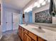 Bright bathroom featuring a double sink vanity, large mirror, and neutral walls at 1022 Mallard Head Ln, Mooresville, NC 28117