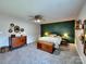 Relaxing bedroom featuring an accent wall, carpet, and stylish decor at 1022 Mallard Head Ln, Mooresville, NC 28117