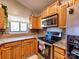 This kitchen shows stainless steel appliances, wood cabinets, and granite countertops at 1022 Mallard Head Ln, Mooresville, NC 28117
