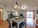 Living room with hardwood floors, vaulted ceilings, and sliding door to a balcony at 1022 Mallard Head Ln, Mooresville, NC 28117