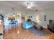 Open-concept living room with hardwood floors, dining area, and access to the kitchen at 1022 Mallard Head Ln, Mooresville, NC 28117