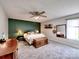 Spacious main bedroom with a modern ceiling fan, area rug, accent wall and natural light at 1022 Mallard Head Ln, Mooresville, NC 28117