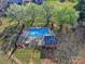 Aerial view of a fenced-in community swimming pool with mature trees and landscaping at 1022 Mallard Head Ln, Mooresville, NC 28117