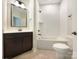 Bathroom with modern vanity, framed mirror, and bathtub with white subway tile surround at 1063 Millview Ln, Matthews, NC 28104