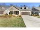Charming one-story home featuring a manicured lawn and a two-car garage, perfect for comfortable living at 1063 Millview Ln, Matthews, NC 28104