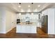 Modern kitchen featuring white cabinets, stainless steel appliances, a large island with seating and granite countertops at 1063 Millview Ln, Matthews, NC 28104
