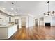 Open-concept living area boasts hardwood floors, a fireplace, and a modern kitchen, perfect for gatherings at 1063 Millview Ln, Matthews, NC 28104