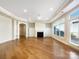 Bright living room featuring hardwood floors, a fireplace and large windows allowing for ample natural light at 1063 Millview Ln, Matthews, NC 28104