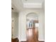 An arched doorway leads to an open living area with hardwood floors and a sliding glass door at 1063 Millview Ln, Matthews, NC 28104