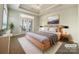 Cozy bedroom featuring hardwood floors, a ceiling fan and French doors allowing for ample natural light at 1063 Millview Ln, Matthews, NC 28104