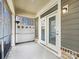 Covered patio with exterior lighting and white framed glass doors at 1063 Millview Ln, Matthews, NC 28104