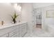 Tastefully designed bathroom with dual vanities, quartz countertop, stylish fixtures, and a view of the walk-in closet at 109 Seldon Dr, Charlotte, NC 28216