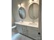 Bathroom featuring double sink vanity, oval mirrors, and tile flooring at 109 Seldon Dr, Charlotte, NC 28216