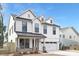 Beautiful two-story home with white siding, black accents, dormer windows, and a two-car garage at 109 Seldon Dr, Charlotte, NC 28216