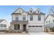 Stunning two-story home showcasing a modern design with white siding, black accents, and a welcoming front porch at 109 Seldon Dr, Charlotte, NC 28216