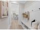 Hallway with a bench and coat hooks leads to an open kitchen with island seating at 109 Seldon Dr, Charlotte, NC 28216