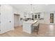 Bright, modern kitchen with white cabinets, stone countertops, a large island, and stainless appliances at 109 Seldon Dr, Charlotte, NC 28216