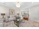 Elegant living room featuring stylish seating, modern decor, and an open view into the kitchen at 109 Seldon Dr, Charlotte, NC 28216