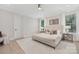 Serene bedroom featuring neutral tones, plush bedding, and natural light from large windows at 109 Seldon Dr, Charlotte, NC 28216