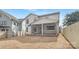 Rear exterior view showcasing a home with a screened-in porch, a spacious yard and fenced property line at 109 Seldon Dr, Charlotte, NC 28216