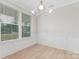 Bright room with light wood floors, crisp white wainscoting, a modern light fixture, and natural light at 109 Seldon Dr, Charlotte, NC 28216