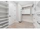 Bright walk-in closet features custom shelving, drawers, and ample storage, illuminated by recessed lighting at 109 Seldon Dr, Charlotte, NC 28216