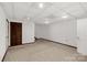 A spacious basement area featuring carpet flooring and paneled doors for storage and access to other spaces at 11 Woodvine Ln, Clover, SC 29710