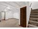 A spacious basement area featuring carpet flooring, paneled doors, and an easy access to the staircase at 11 Woodvine Ln, Clover, SC 29710