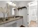 Bright bathroom with a granite countertop vanity, decorative mirror, and wood-look flooring at 11 Woodvine Ln, Clover, SC 29710