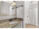 The bathroom features a granite countertop vanity, a decorative mirror and a tiled floor at 11 Woodvine Ln, Clover, SC 29710
