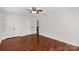 Bedroom with hardwood floors, white walls, ceiling fan, and dual closets and doorways at 11 Woodvine Ln, Clover, SC 29710