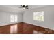 A spacious bedroom with hardwood floors, two windows and white walls at 11 Woodvine Ln, Clover, SC 29710