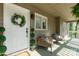Inviting front porch with seating area, decorative plants, and a charming wreath on the front door at 11 Woodvine Ln, Clover, SC 29710