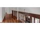 Upstairs hallway with wooden railing and hardwood floors at 11 Woodvine Ln, Clover, SC 29710