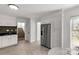 Bright kitchen with stainless refrigerator, tile floors, and view of the staircase at 11 Woodvine Ln, Clover, SC 29710