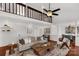 Cozy living room with a soaring ceiling, hardwood floors, and a comfortable sofa under a loft at 11 Woodvine Ln, Clover, SC 29710